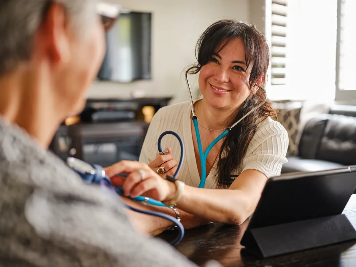 Home healthcare provider assisting patient